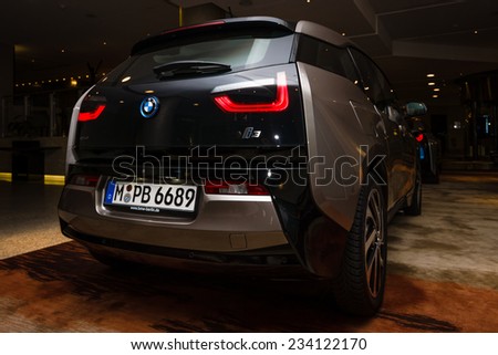 BERLIN - NOVEMBER 28, 2014: Showroom. The BMW i3, previously Mega City Vehicle (MCV), is a five-door urban electric car developed by the German manufacturer BMW. Rear view.