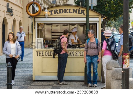 PRAGUE, CZECH REPUBLIC - SEPTEMBER 18, 2014: Preparation and sale trdelnik (Trdlo) - Czech traditional sweet pastries. Prague is the capital and largest city of the Czech Republic.