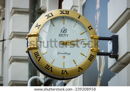 PRAGUE, CZECH REPUBLIC - SEPTEMBER 18, 2014: Signboard in the form of large wall clocks, shops selling watches, gold jewelry and accessories \