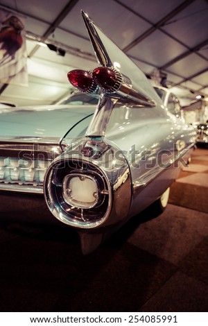 MAASTRICHT, NETHERLANDS - JANUARY 08, 2015: The rear brake lights a full-size luxury car Cadillac Coupe de Ville, 1959. Stylization. Vintage toning. Int. Exhibition InterClassics & Topmobiel 2015