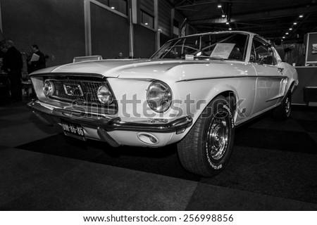 MAASTRICHT, NETHERLANDS - JANUARY 09, 2015: A pony car Ford Mustang GT Fastback, 1968. Black and white. International Exhibition InterClassics & Topmobiel 2015
