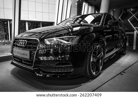 BERLIN - MARCH 08, 2015: Showroom. Compact executive car Audi A3 1.8 T quattro. Black and white. Audi A3 is a winner World Car of the Year 2014