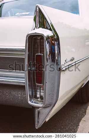 BERLIN - MAY 10, 2015: The rear brake lights full-size luxury car Cadillac Sedan De Ville. Stylization. Vintage toning. 28th Berlin-Brandenburg Oldtimer Day
