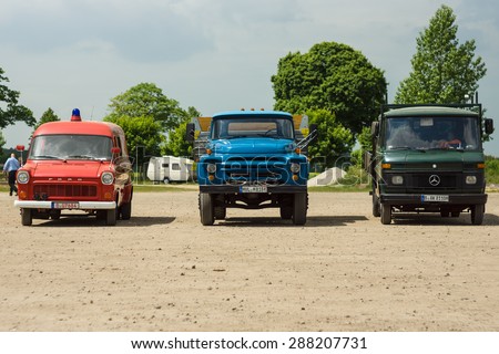 PAAREN IM GLIEN, GERMANY - MAY 23, 2015: Commercial trucks Ford Transit (left), a popular soviet truck ZIL-130 (center), Mercedes-Benz T2 (right). The oldtimer show in MAFZ.