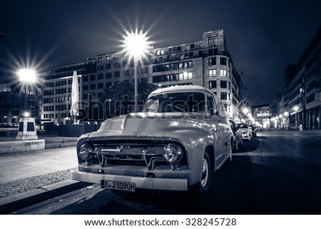 BERLIN, GERMANY - OCTOBER 13, 2015: Full-size pickup truck Ford F100 Panel Van, 1953 (second generation) on the night street. Stylization. Toning. Ford F-Series - is a popular American pickup.