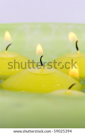 Burning candles in the water.