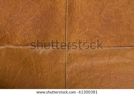 The texture of the old, brown leather stitched patches.