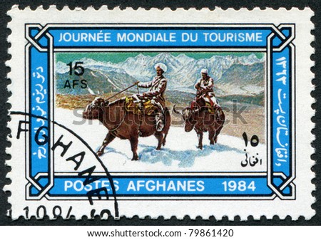 AFGHANISTAN - CIRCA 1984: A stamp printed in the Afghanistan devoted to World Tourism Day. Depicts Buffalo riders in snow, circa 1984