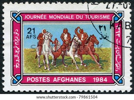 AFGHANISTAN - CIRCA 1984: A stamp printed in the Afghanistan devoted to World Tourism Day. Depicted Horsemen playing buzkashi, circa 1984