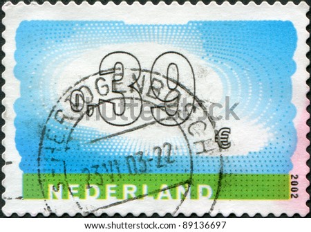 NETHERLANDS - CIRCA 2002: A stamp printed in the Netherlands, shows a natural landscape, cloudy sky and the earth, circa 2002