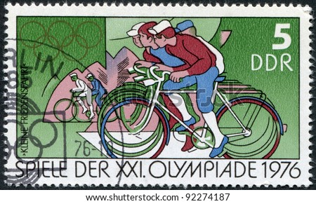 DDR - CIRCA 1976: A stamp printed in DDR, devoted to the Summer Olympics in Montreal, depicts Peace Bicycle Race and Olympic Rings, circa 1976