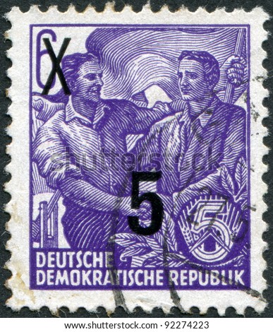 DDR - CIRCA 1953: A stamp printed in DDR, shows the German and Soviet workers shake hands (overprint 1954), circa 1953