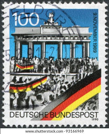 GERMANY - CIRCA 1990: A stamp printed in Germany, is dedicated to the first anniversary of the fall of the Berlin Wall shows people around the Brandenburg Gate, circa 1990