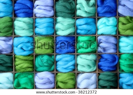 Green and blue felt wool in wooden box