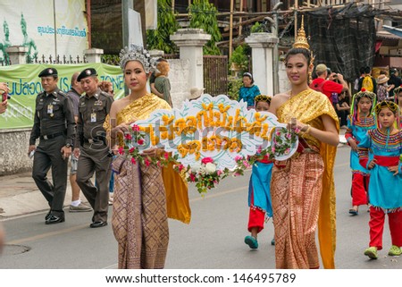 CHIANG MAI,THAILAND-FEB.2 : Chiang Mai Flower Festival, Unidentified men and women in parade annual Chiang Mai flower festival. on Feb.2, 2013 in Chiang Mai,Thailand.