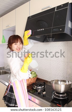 A Chinese woman is cleaning in the kitchen.