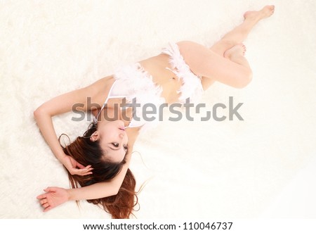 Woman lie down on a white Blanket.