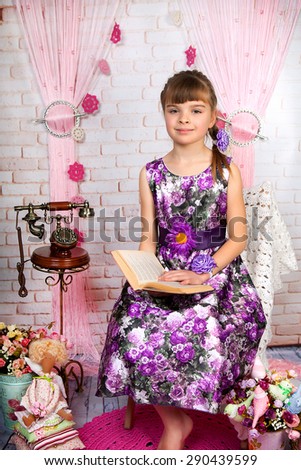 teen girl in a beautiful purple dress with a book in the scenery with old phone