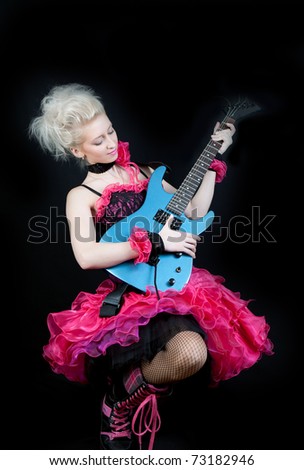 beautiful blonde in black and pink dress with an electric guitar