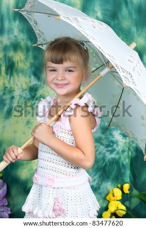 portrait of a pretty girl with an openwork knitted dress umbrella