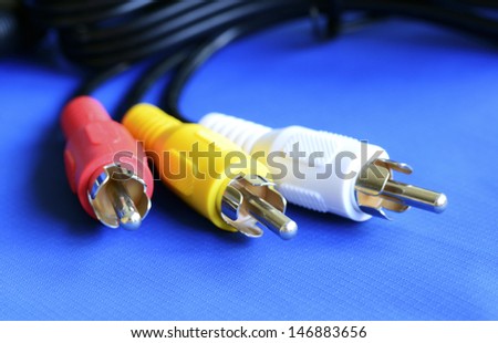 Cable to the TV isolated on blue concept of entertainment and communication