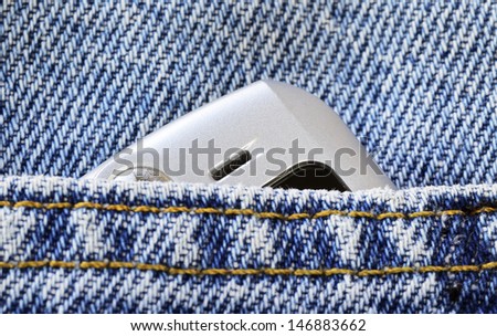 Cellular phone in the jeans pocket concept of communication and style