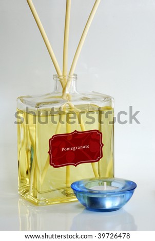 Fragrance oil with scented diffuser and a blue candle holder