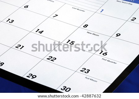 Planning the new month from a calendar isolated on blue
