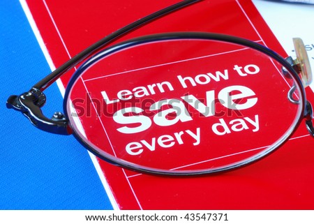 Focus on learning how to save money everyday isolated on blue