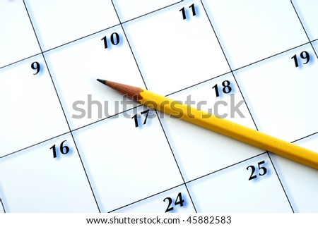Planning the new month from a calendar with a pencil