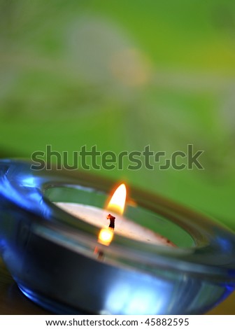 A scented candle at the zen green background