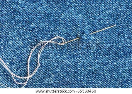 The needle with a thread through the jean