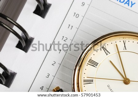 A close up view of the watch and day planner