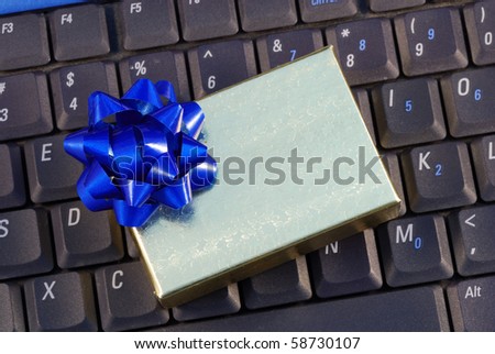 Holiday gift box on a keyboard concepts of holiday online shopping