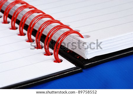 Close up view on the red spiral rings notebook concept of education or business meeting