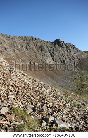 Scree slopes lead to the towering cliffs of the north face of Crib Goch, Snowdonia national park, Wales, UK.