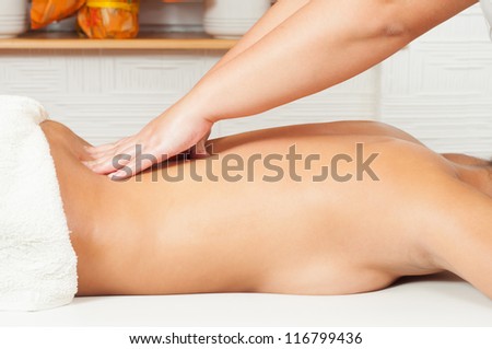 Young women getting back massage in massage salon.