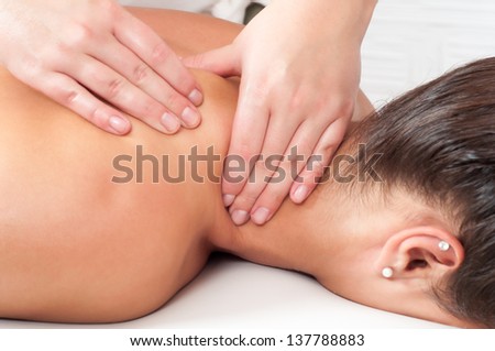 Young woman getting massage in massage salon.