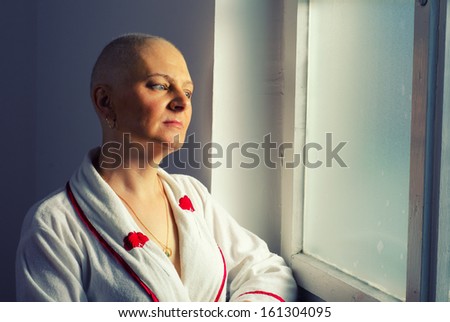 Bald Woman Suffering From Cancer Looking Through The Hospital Window.