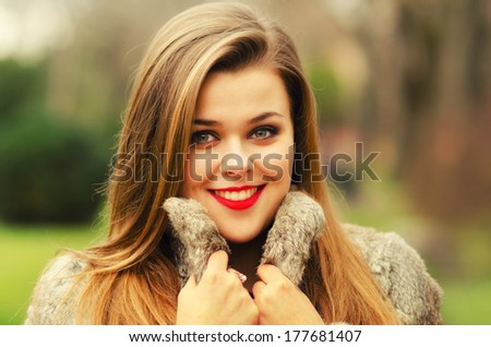 Beautiful glamorous lady having fun outdoor on gloomy winter day.