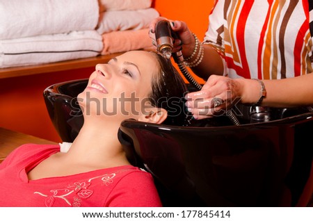 Girl washing hair in hairdressing salon.