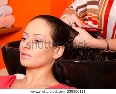 Girl washing hair in hairdressing salon.