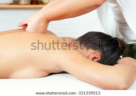 Young women getting back massage in massage salon.