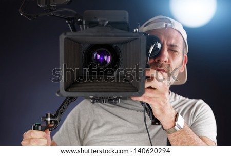 camera operator working with a cinema camera on his shoulder