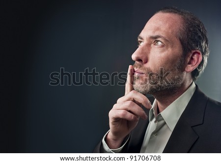 Studio shot of businessman in a deep thought over colored background