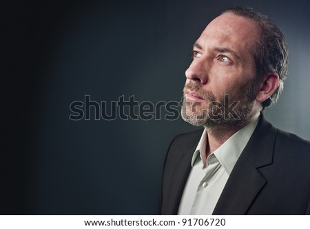 Portrait of a serious mature man isolated over colored background