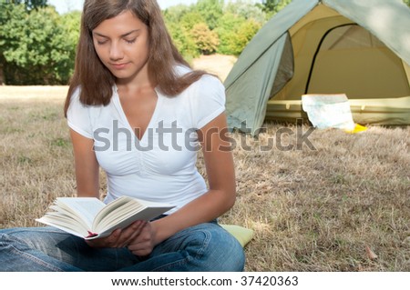 woman tent camping book