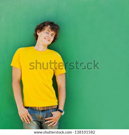 Man With Curly Hair In A Yellow T-Shirt