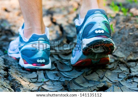 athlete running sport feet on trail healthy lifestyle