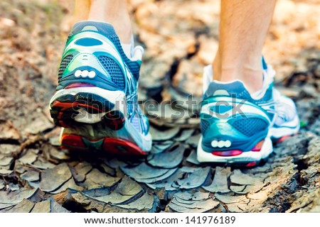 athlete running sport feet on trail healthy lifestyle